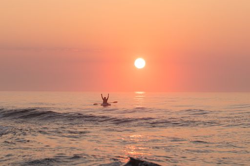 A man on the sailing boat during sunset