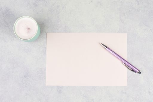 Empty paper with a pen and a cup of coffee, textured background, brainstorming for new ideas, writing a message, taking a break, home office desk