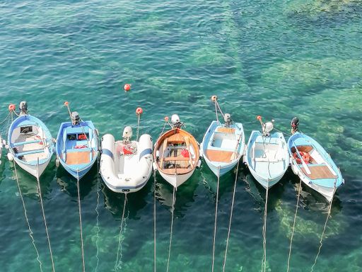 A high angle shot of boats docked on the beach of Cinque Terre, Italy