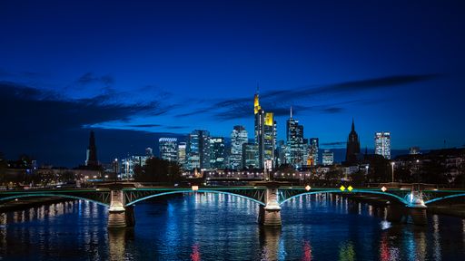 The illuminated Frankfurt am Main skyline against a blue night sky