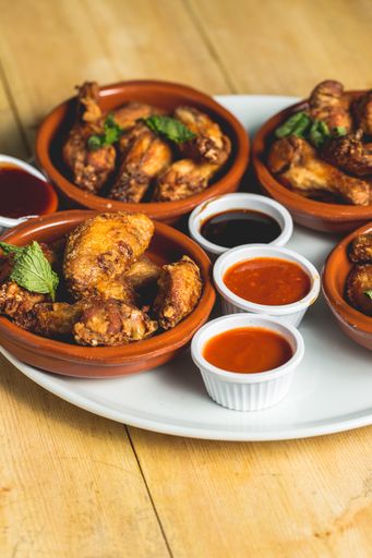 A plate of served Chinese tapas with sauces