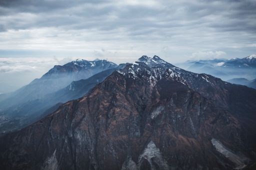 An aerial shot of snowy mountains of Piani dei Resinelli in Lecco, near Como Lombardy, Italy
