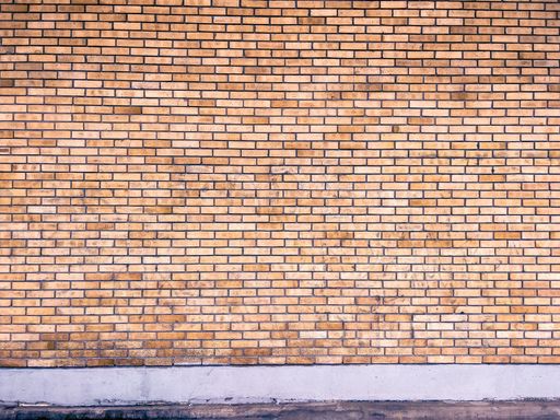 A frontal shot of an exterior brick wall pattern.