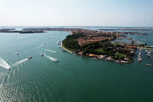 An aerial shot of the landscape with sea and boats on a sunny day in Venice, Italy