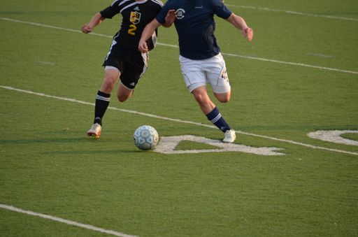 A view of two soccer players competing for a ball