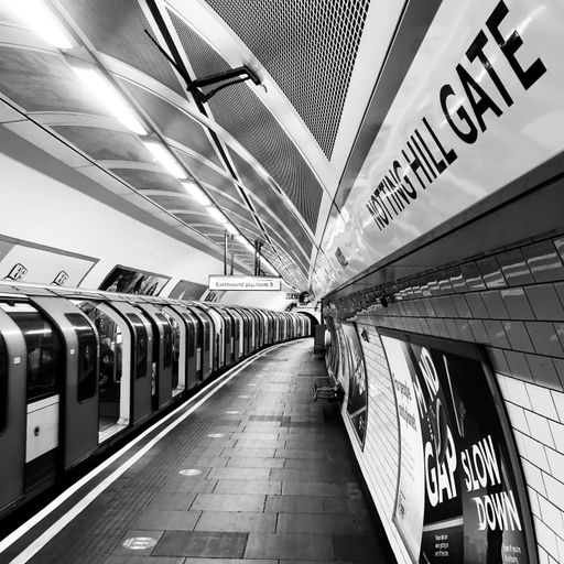 A grayscale shot of the train in The London Underground Notting hill station