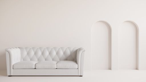 A white sofa on white floor and same color of wall with arch design