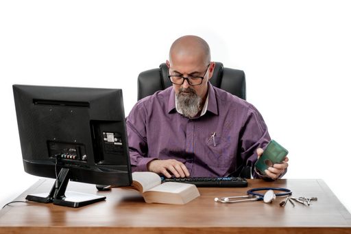 A portrait of a doctor doing research in his office isolated on white background, Madrid