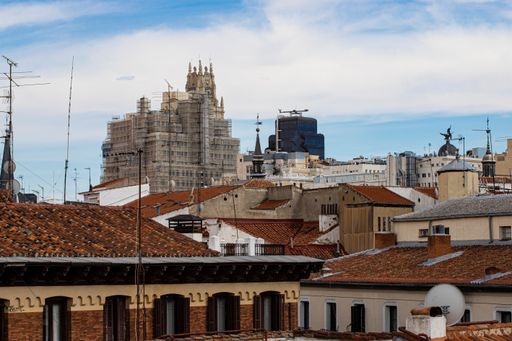An aerial shot of orange roofs of the buildings in Madrid