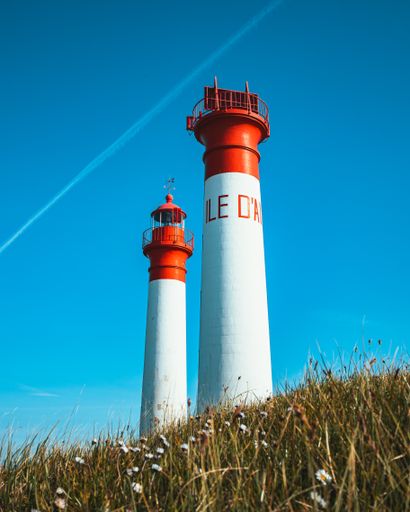 A low angle shot of the Aix island lighthouses landmark in Ile-d'Aix, France against a blue sky