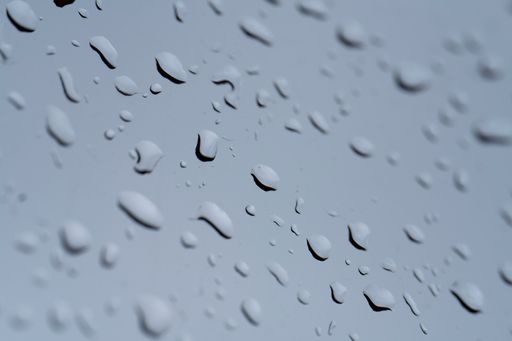 A macro view of rainwater drops on the window