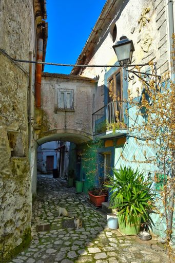 A narrow street through an arch in the medieval village of Pietramelara in the province of Caserta, Italy.