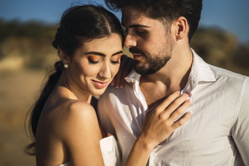 A caucasian loving couple hugging in the beach