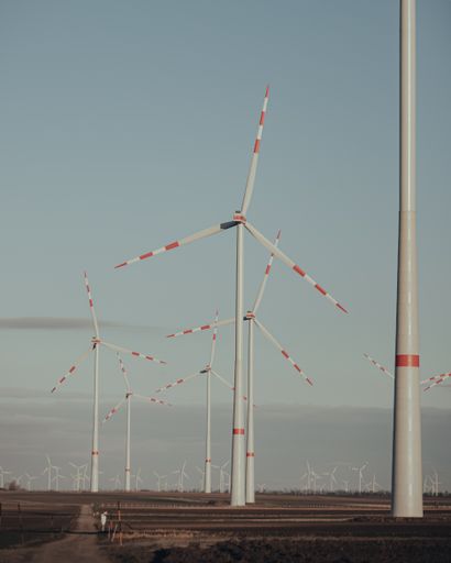 A rural field with modern wind turbines