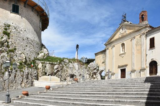 A beautiful shot of stairs in the square of the town of Macchiagodena in southern Italy and a blue sky