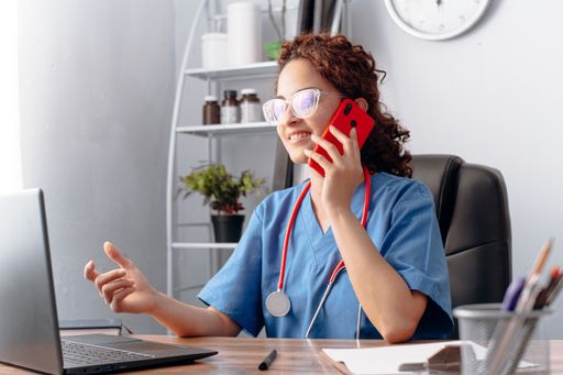 A young doctor girl working with laptop in the cabinet with tonometer on the neck