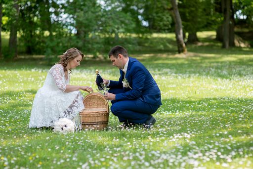 A Caucasian young groom and bride in a wedding day in a park