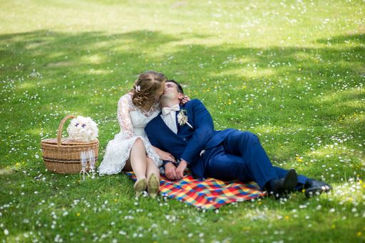 A Caucasian young groom and bride in a wedding day in a park