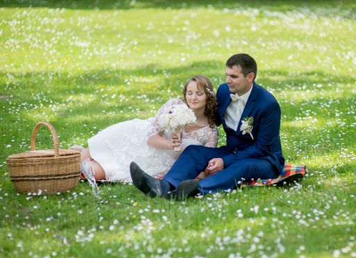 A Caucasian young groom and bride in a wedding day in a park