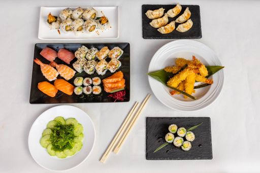 A top view  of sushi set on black and white plates on a white background