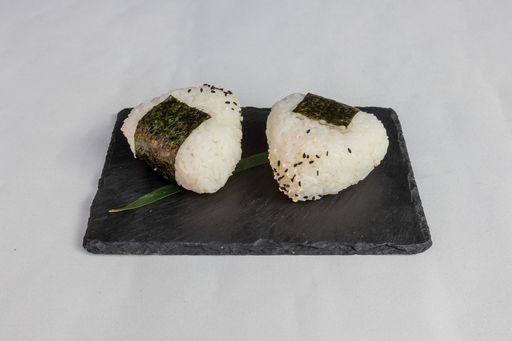 A Top view of sushi set on a black plate on a white background