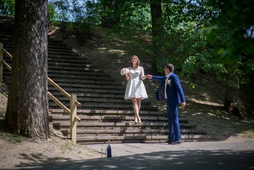 A Caucasian young groom and bride in a wedding day in a park