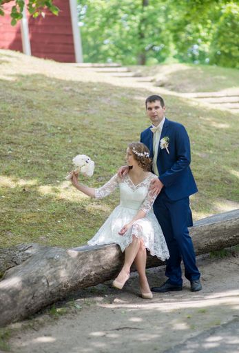 A Caucasian young groom and bride in a wedding day in a park
