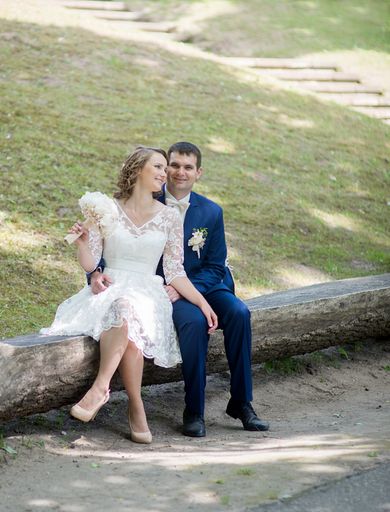 A Caucasian young groom and bride in a wedding day in a park