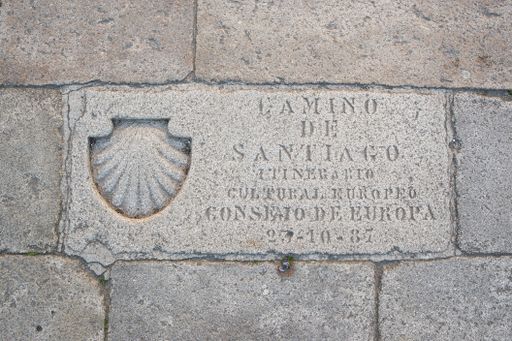 Shell Symbol and text engraved in stone Camino de Santiago. Culture Route of the Council of Europe. Obradoiro square, Santiago de Compostela