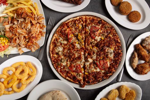 A top view of delicious varieties of freshly prepared Pakistani dishes on a rustic background
