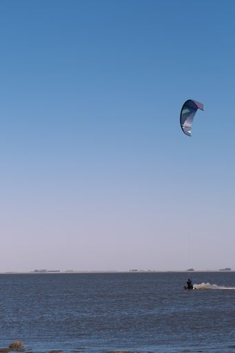 A vertical shot of a Caucasian kitesurfer in Argentina