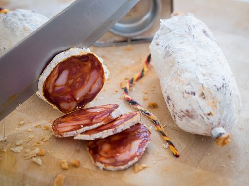 A closeup shot of sliced sausage on a cutting board