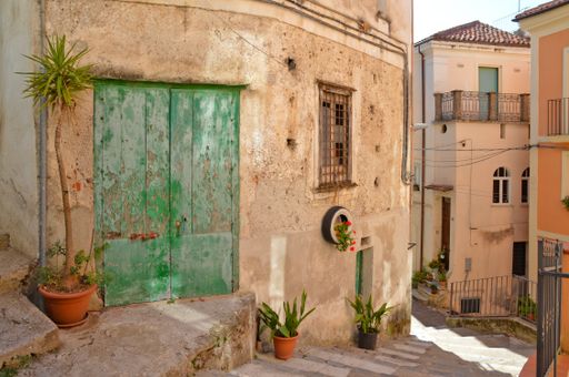 A narrow street with old houses and plants in Rivello, a village in the Basilicata region in Italy
