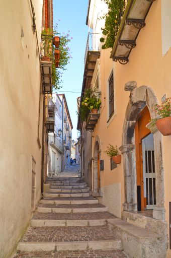 A narrow street with old houses and plants in Rivello, a village in the Basilicata region in Italy