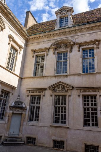 A vertical shot of the historical buildings in downtown Dijon, France.
