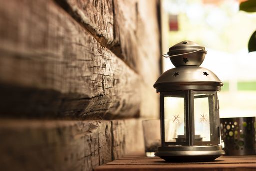 A beautiful steel lantern lamp on the wooden table