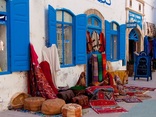 A number of beautiful carpets with abstract decorations on the ground in Essaouira, Morocco
