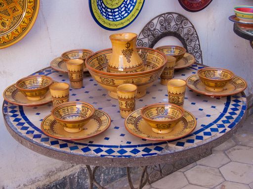 A closeup of plates hanging from the wall and traditional tableware