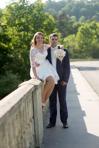 A vertical shot of a young married Caucasian couple posing in nature