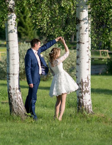 A vertical shot of the loving newlyweds enjoying their time in private in the park