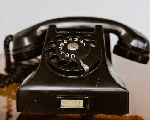 A selective focus shot of a black vintage telephone