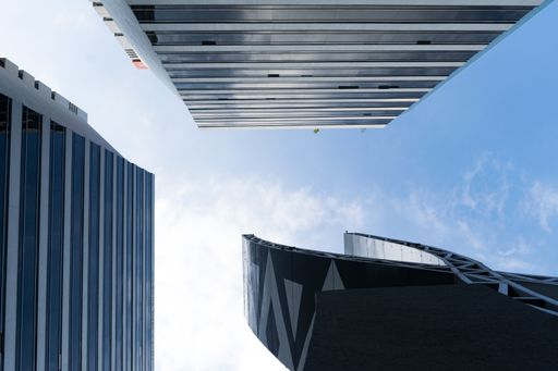 A low angle shot of modern office buildings with blue sky in the background