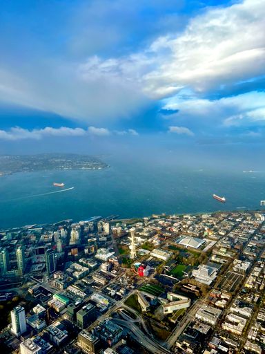 An aerial view of cityscape, Seattle and space needle under cloudy sky