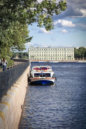 A vertical shot of a boat parked in the lake during daytime