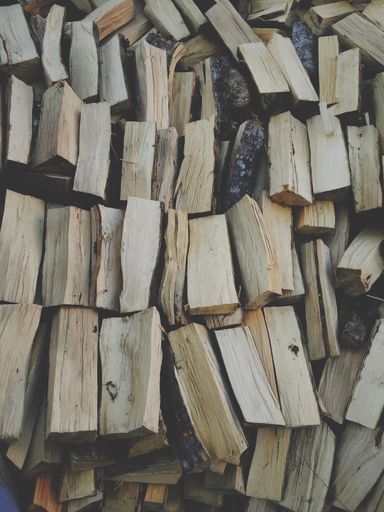 A vertical shot of firewood one on another