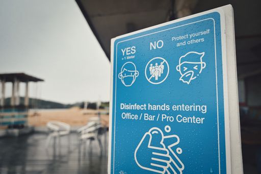 A close up shot of a pandemic prevention sign in an empty beach bar in Italy