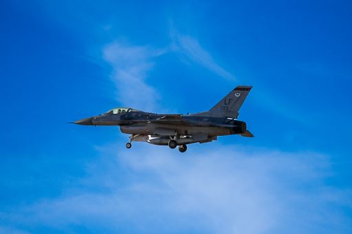 A Luke airbase f16 military plane flying in the vibrant cloudy sky in Phoenix, Arizona