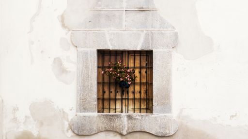 An old wooden window on a white wall