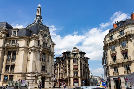 A beautiful shot of La Poste Dijon Grangier and Anny B buildings against blue cloudy sky on a sunny day in Dijon, France