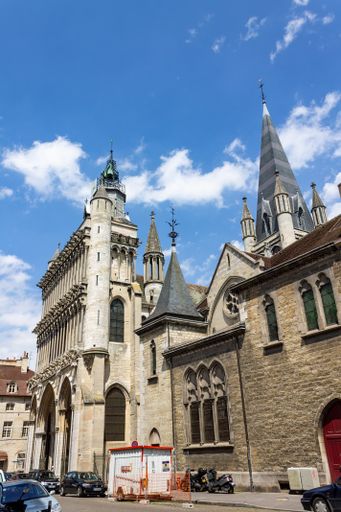 A vertical shot of the historical Notre-Dame de Dijon church against blue sky on a sunny day in France